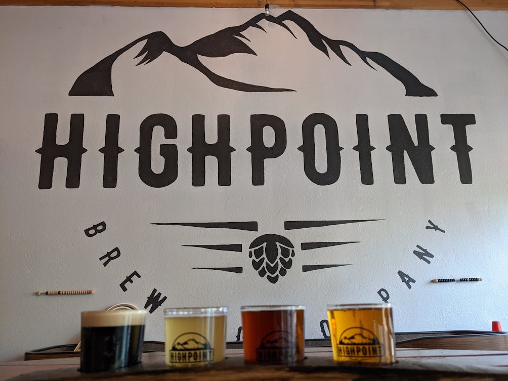 Sign of Highpoint Brewing Company with 4 Sample Beers in glasses in the foreground