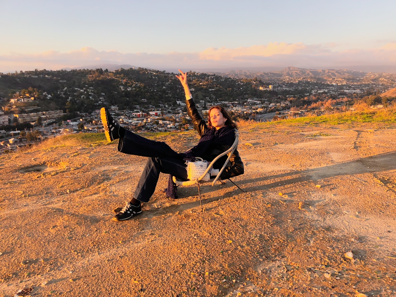 Person enjoying a summit view of Los Angeles from a peak in Debs Regional Park 