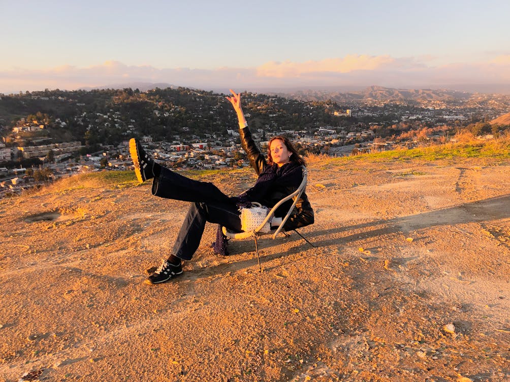 Person enjoying a summit view of Los Angeles from a peak in Debs Regional Park 