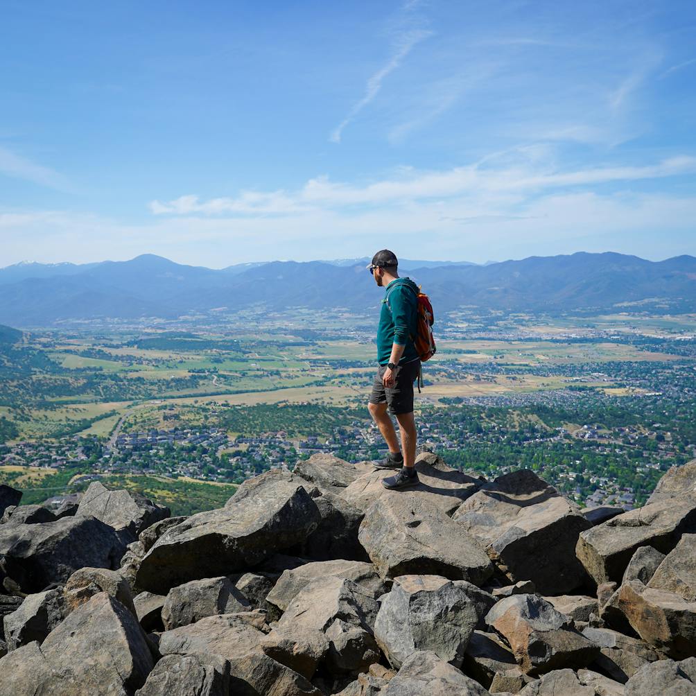 A hiker on a rock pile at Upper Table Rock Southern Oregon