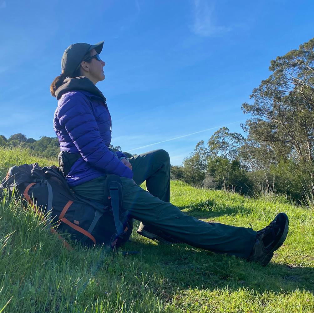 Hiker sitting on her backpack taking a break at Carr Ranch Loop in Contra Costa County 