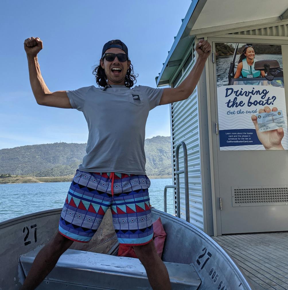 Young man posing for the camera on a boat at the dock at Lake Casitas near Ventura 