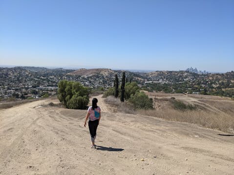 Hiker on wide open trail at Elephant Hill Open Space in Los Angeles 