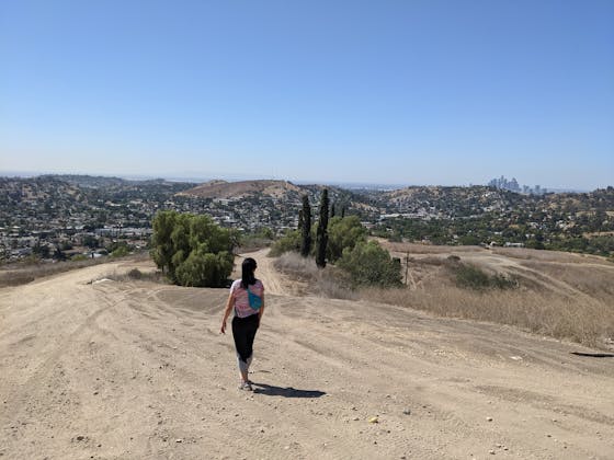 Hiker on wide open trail at Elephant Hill Open Space in Los Angeles