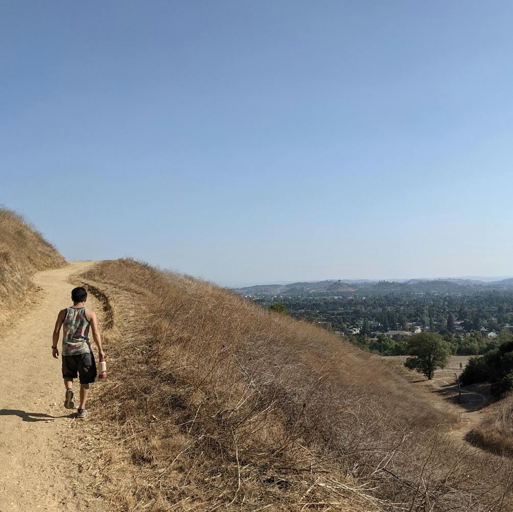 Hiker walking a ridge line at Horsethief Canyon Park in San Dimas 