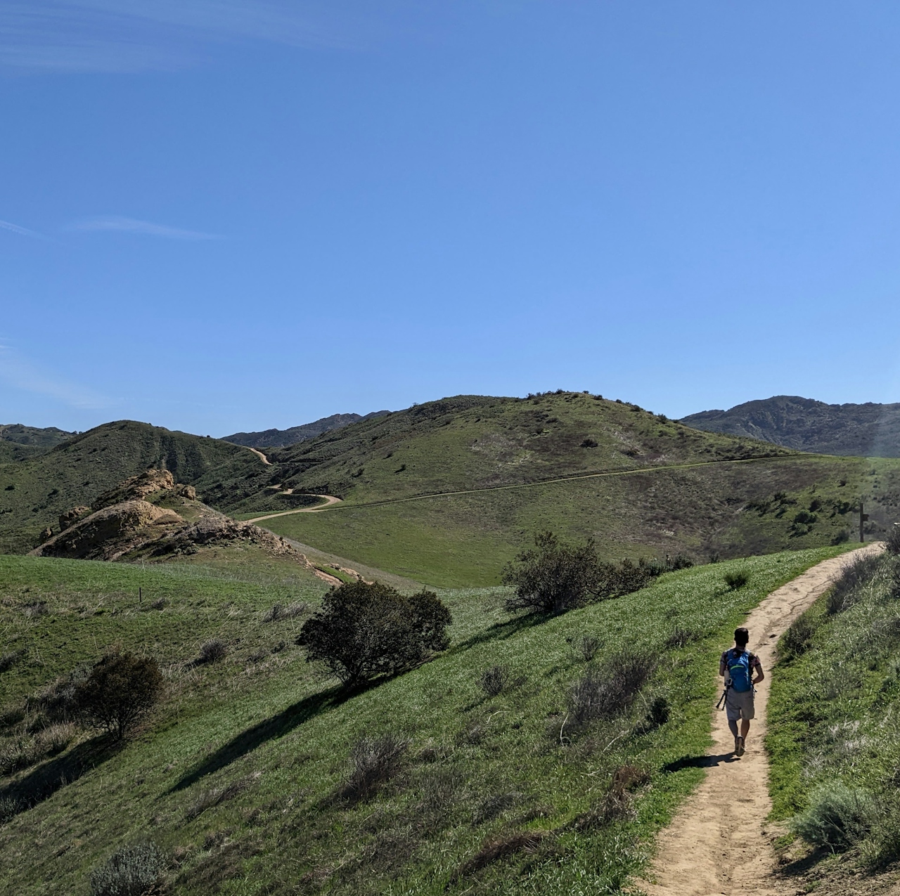 Hiker on rolling hillside hiking trail at Long Canyon in Simi Valley