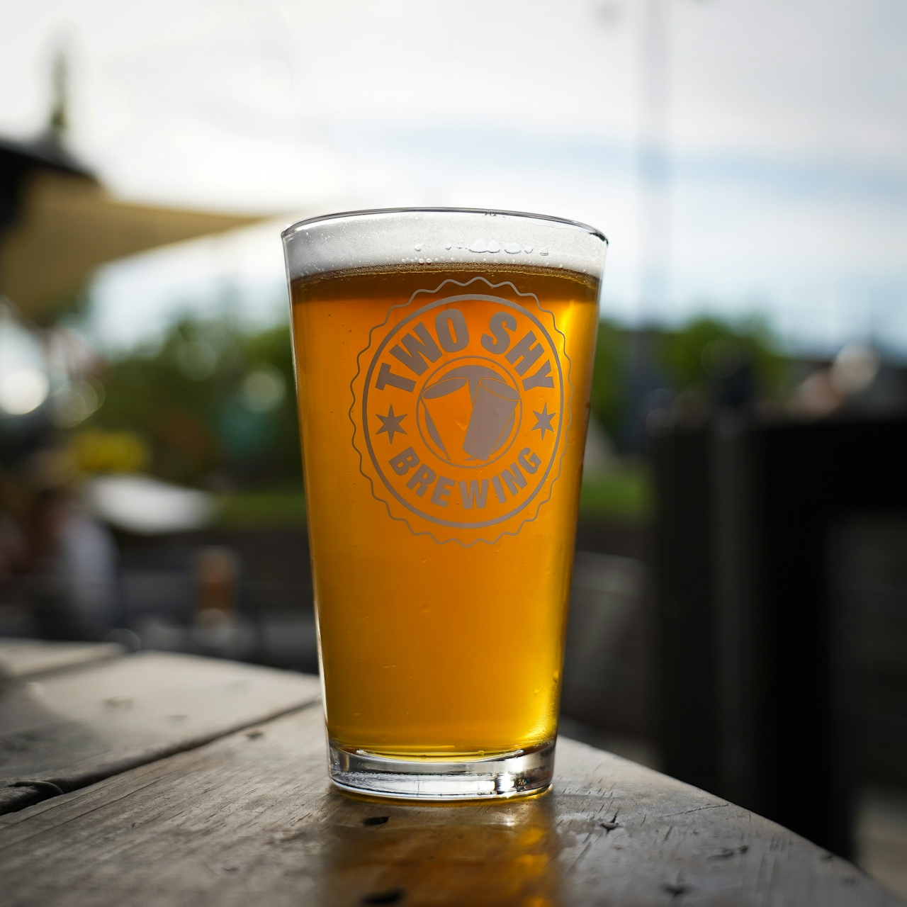 A glass of Two Shy Brewing Beer on a table in downtown Roseburg 