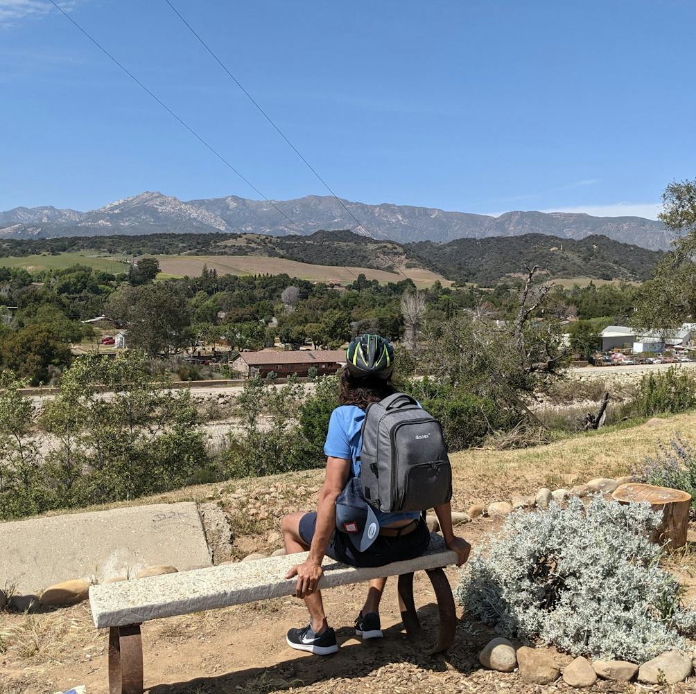 Man sitting on a bench overlooking the scenery on the Ventura to Ojai bike path