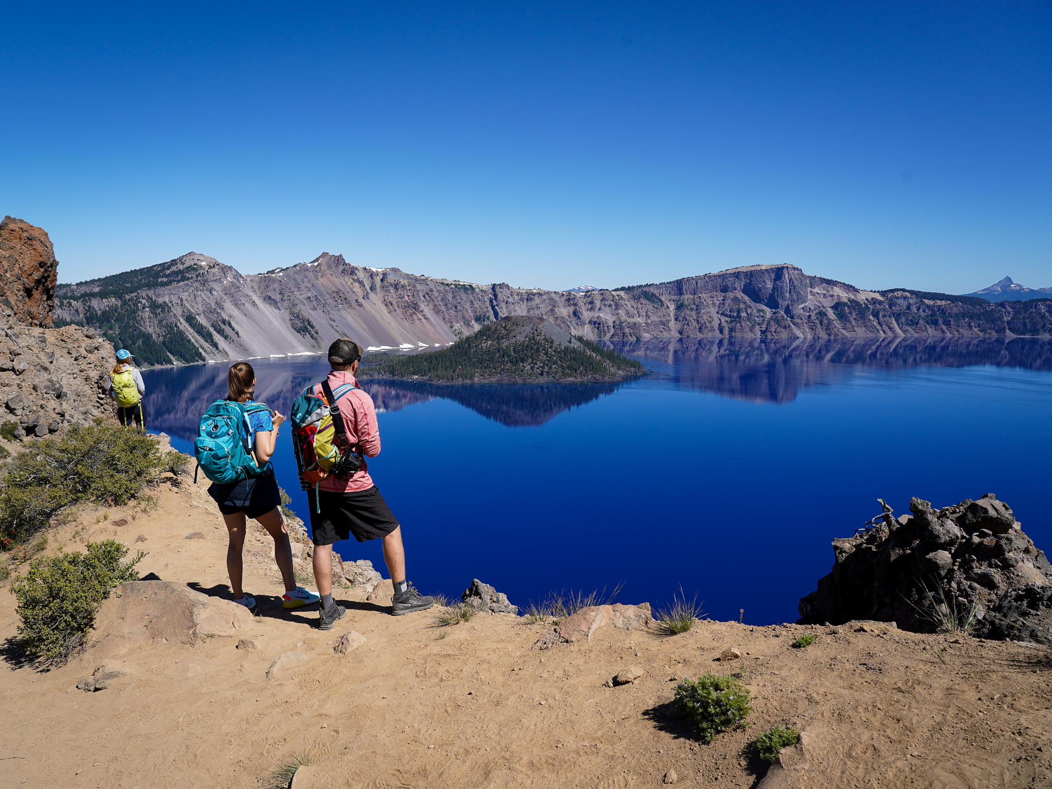 Couple standing at Garfield Peak Overlooking Crater Lake in Crater Lake National Park Southern Oregon