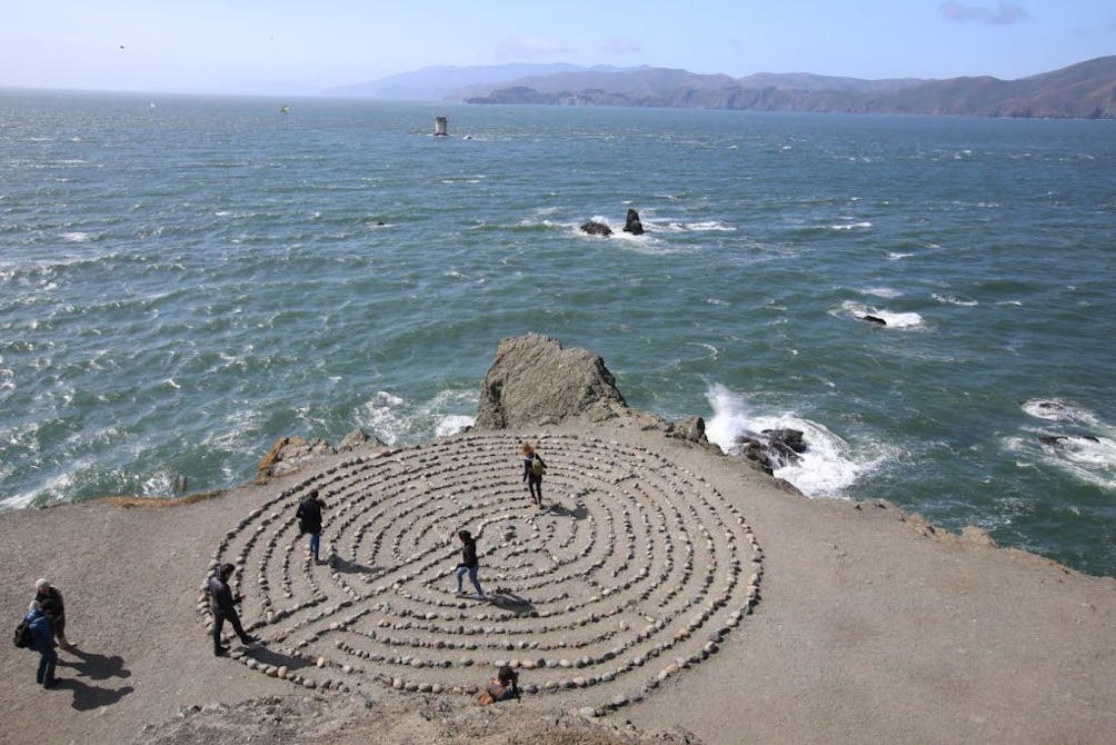People walking th labyrinth in San Francisco near Mile Rock Beach