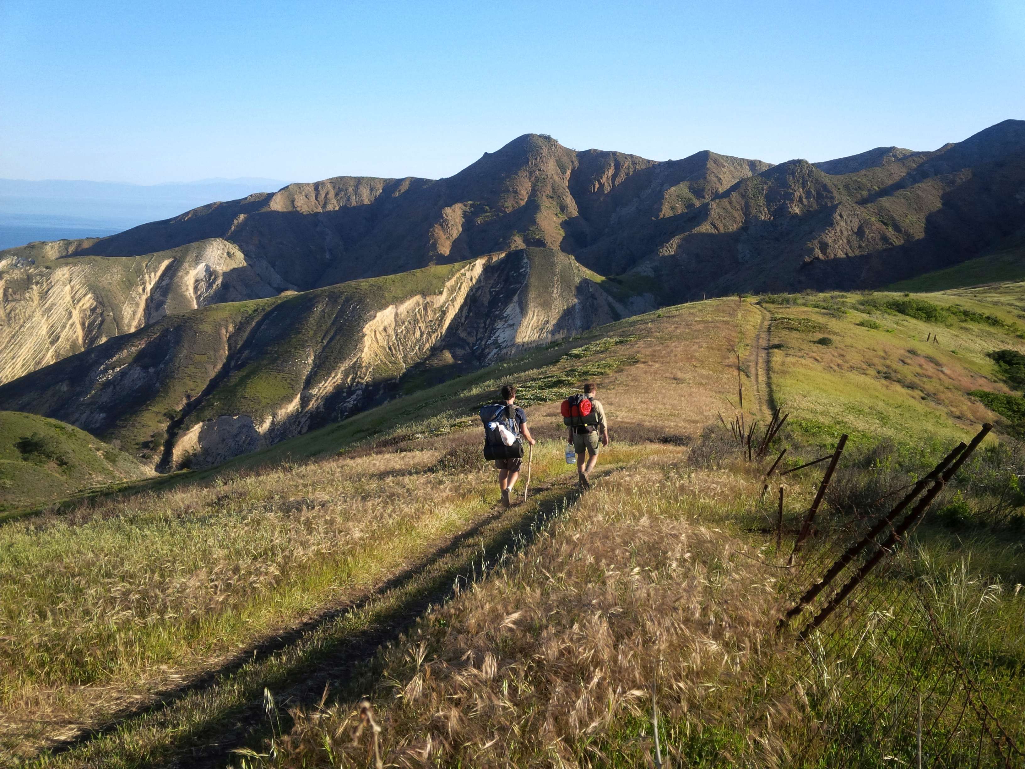 Backpackers traversing the seaside mountain range on Santa Cruz Island in Channel Islands National Park