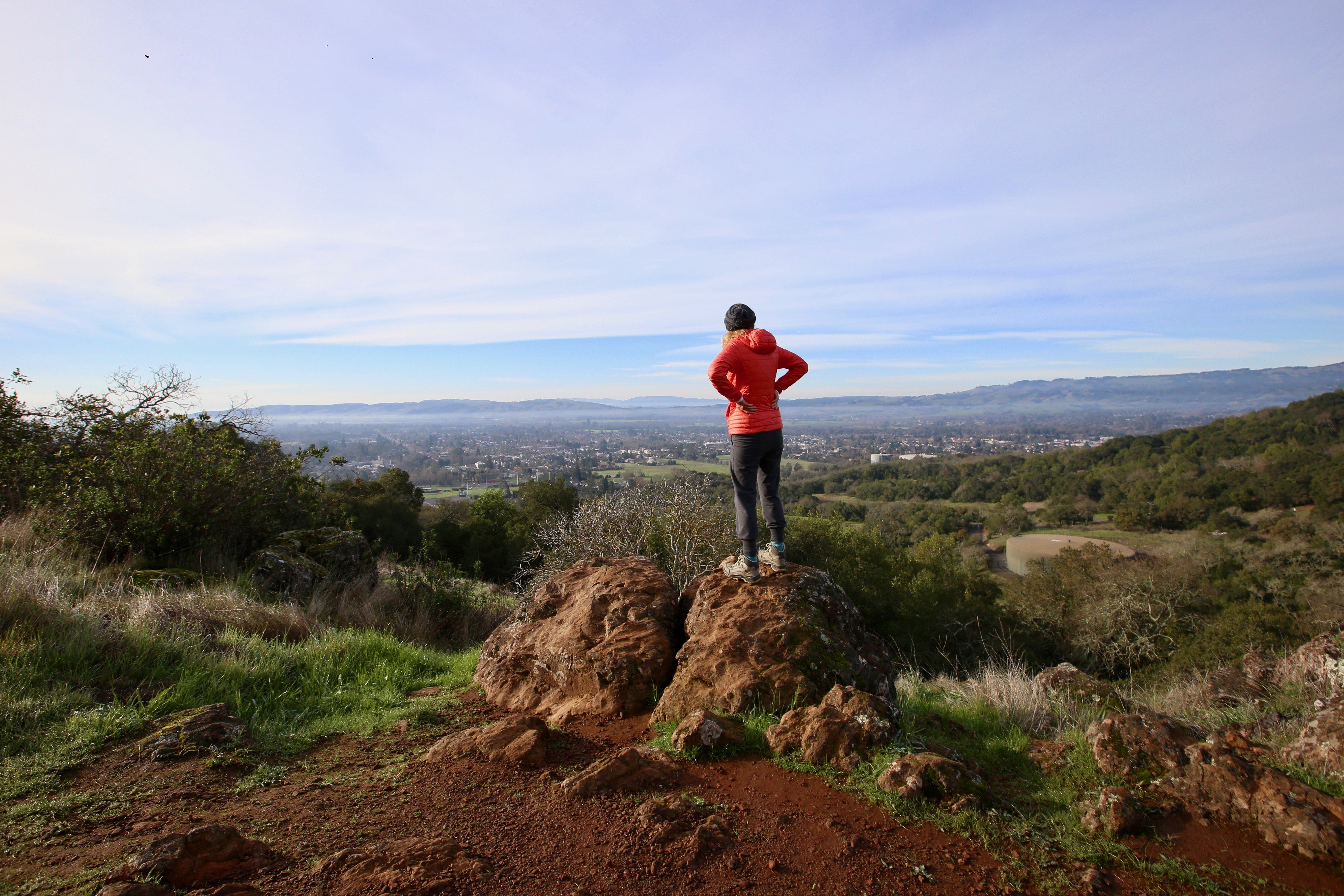 A woman stands and takes in the view of Sonoma Valley on the Sonoma Overlook Trail 