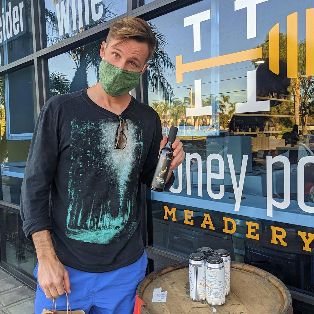 Person standing in front of Honeypot Meadery in Orange County 