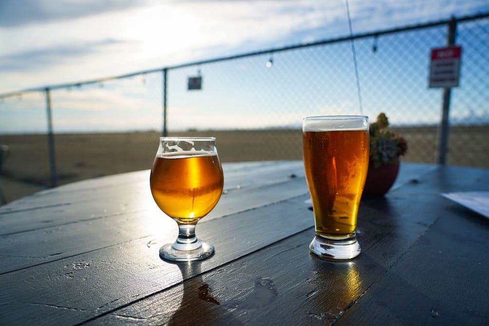 Two beers on a table at Faction Brewing in Alameda