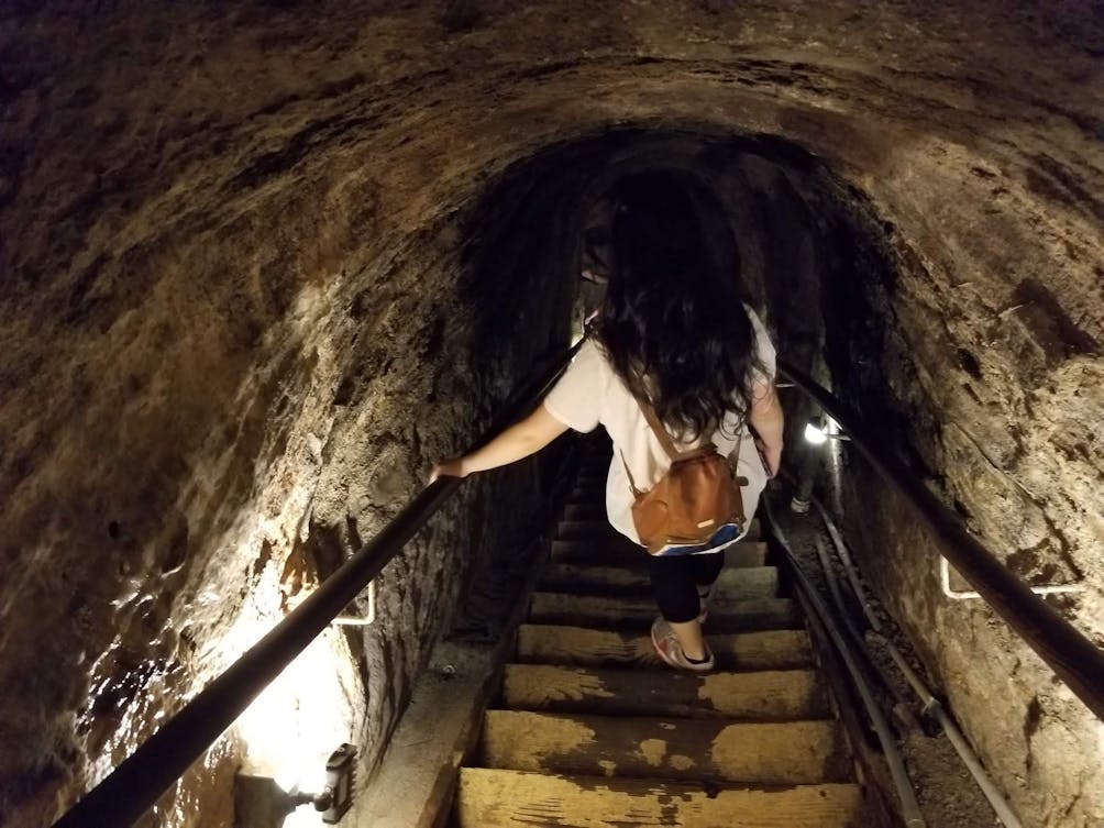 Woman walking down the stairs in Sunny Jim Cave La Jolla 