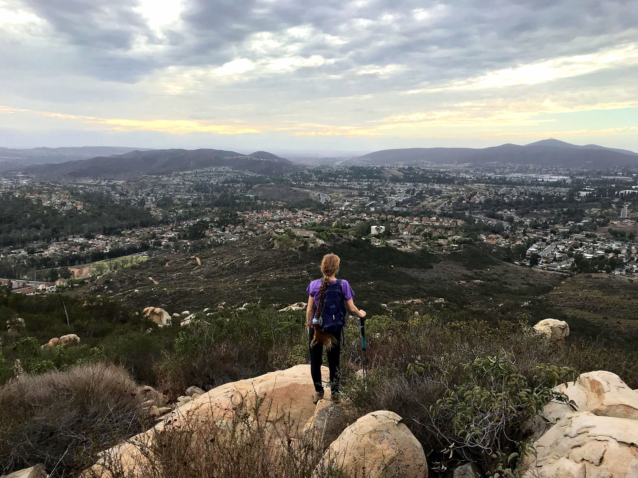 Woman standing at a peak at Twin Peaks in Poway San Diego 
