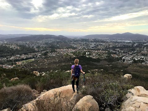 Woman standing at a peak at Twin Peaks in Poway San Diego 