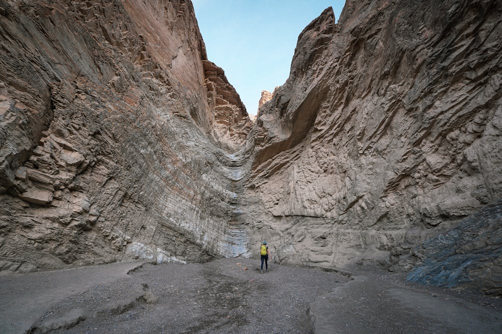Woman standing at the vertical dryfall in Mosaic Canyon at Death Valley National Park 