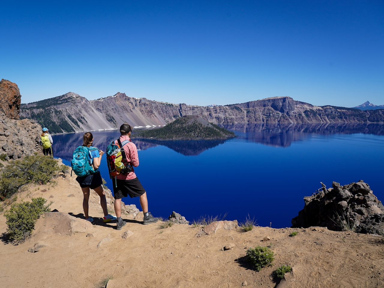 Couple standing at Garfield Peak Overlooking Crater Lake in Crater Lake National Park Southern Oregon