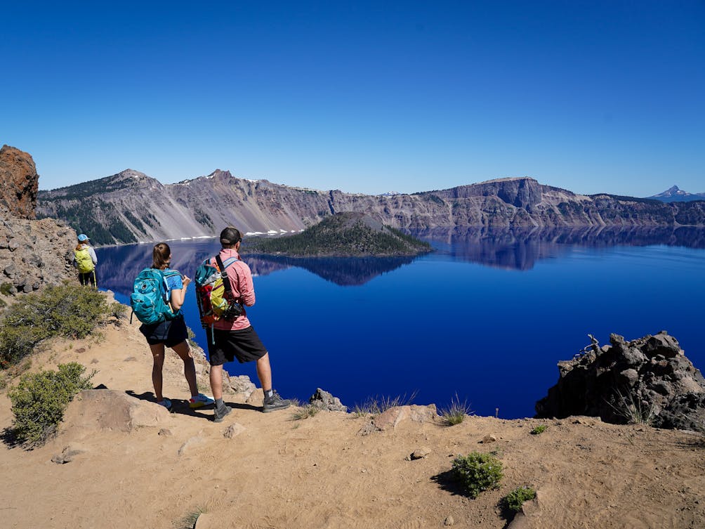Couple standing at Garfield Peak Overlooking Crater Lake in Crater Lake National Park Southern Oregon