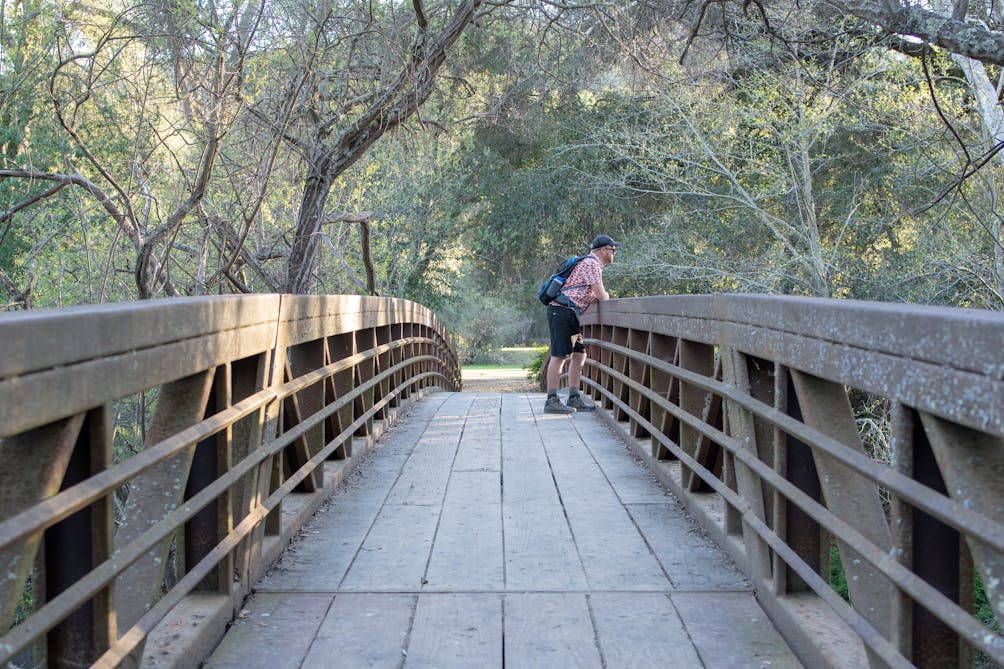 Hiker on bridge at Sunol Wilderness Regional Preserve 