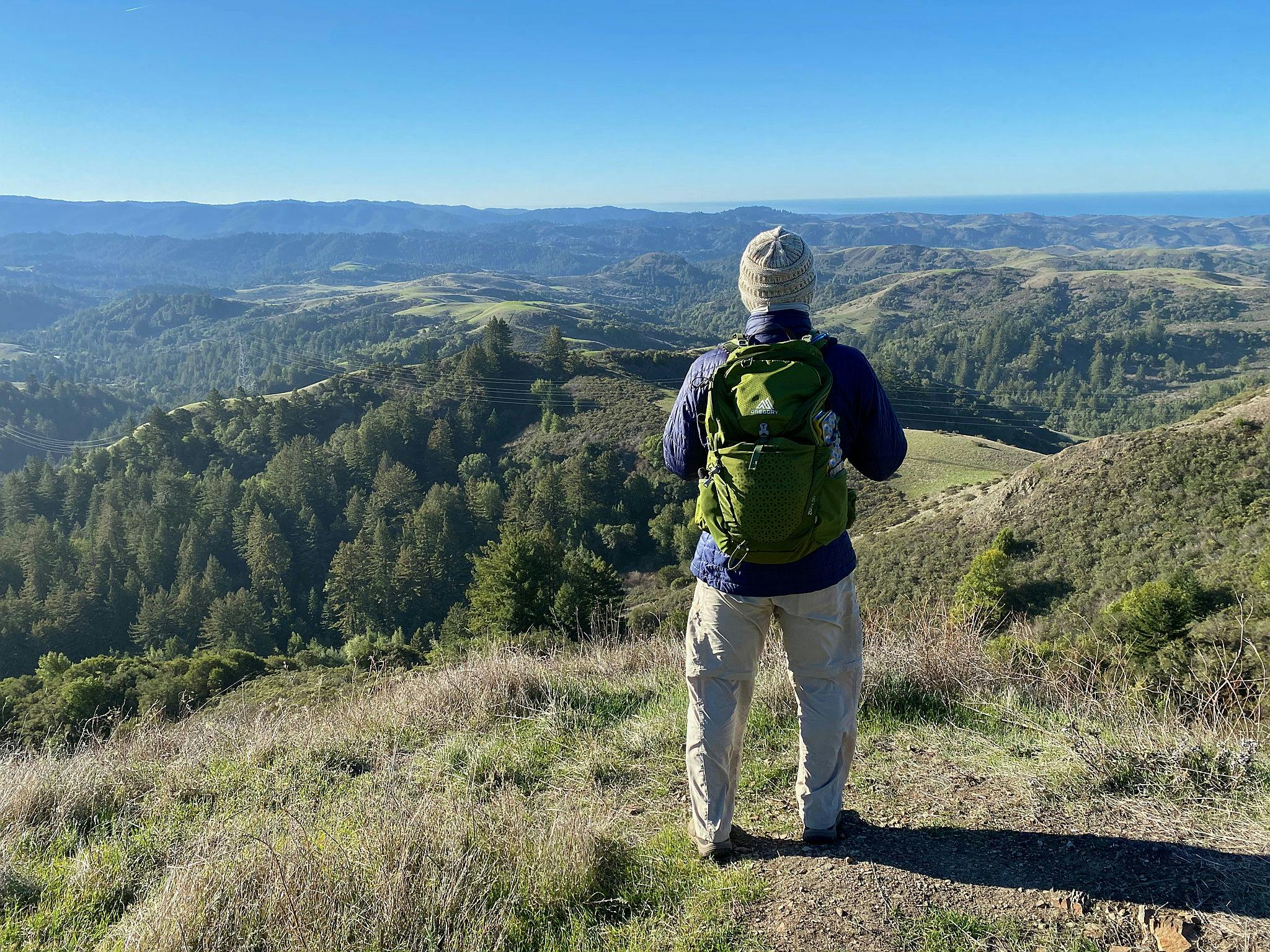 Hiker overlooking the Santa Cruz Mountains at Upper La Honda Creek Preserve