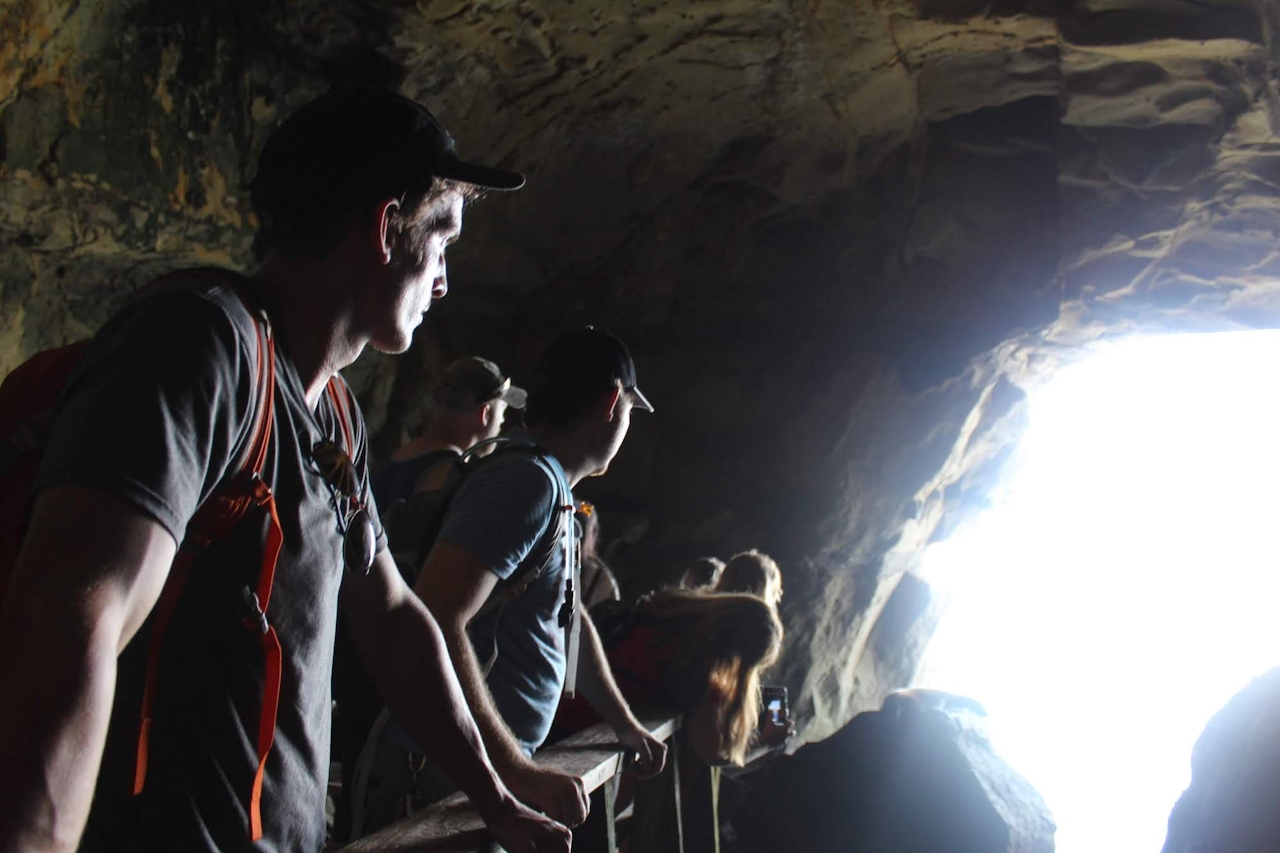 A group of people looking out of Sunny Jim Cave in La Jolla 