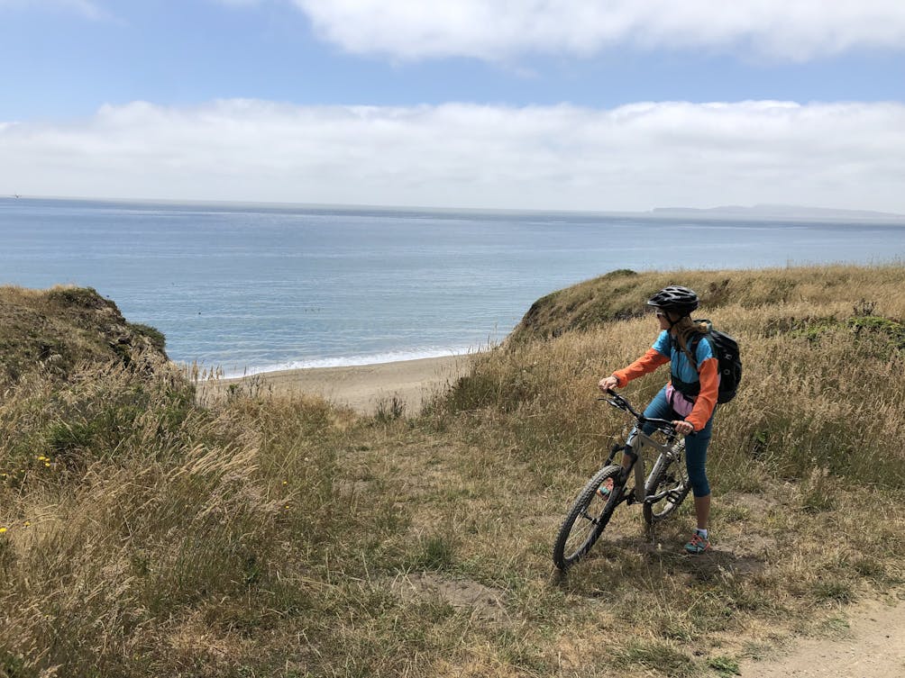 Biker on a trail to Santa Maria Beach in Point Reyes National Seashore 