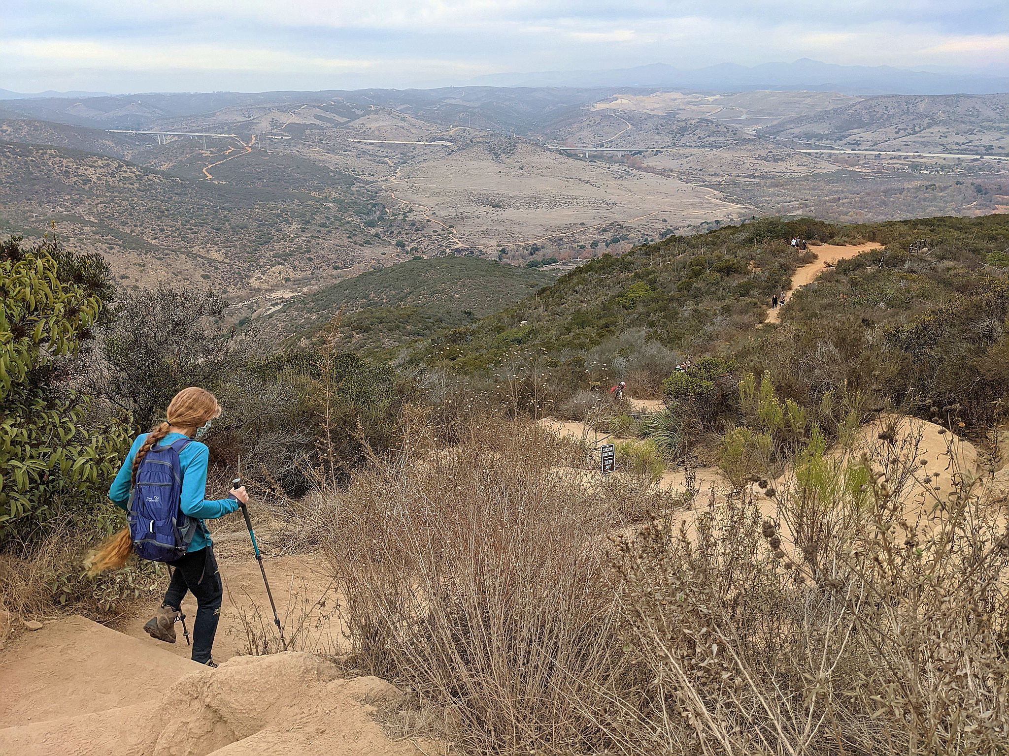 Woman hiking downhill at Kwaay Paay in Mission Trails Regional Park San Diego County 