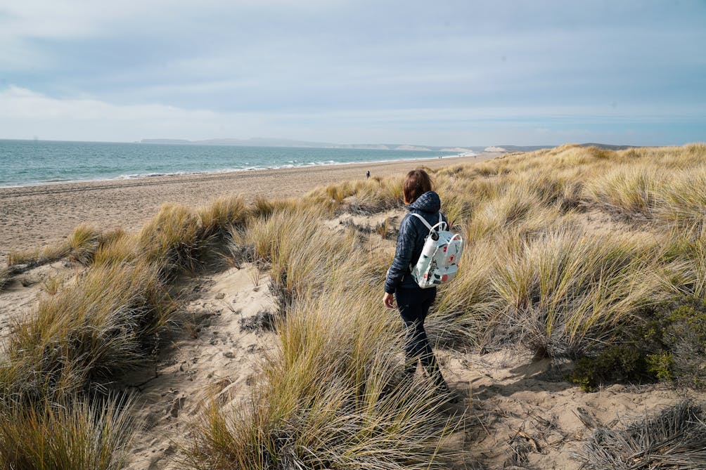 Woman hiking at Limantour Beach in Point Reyes