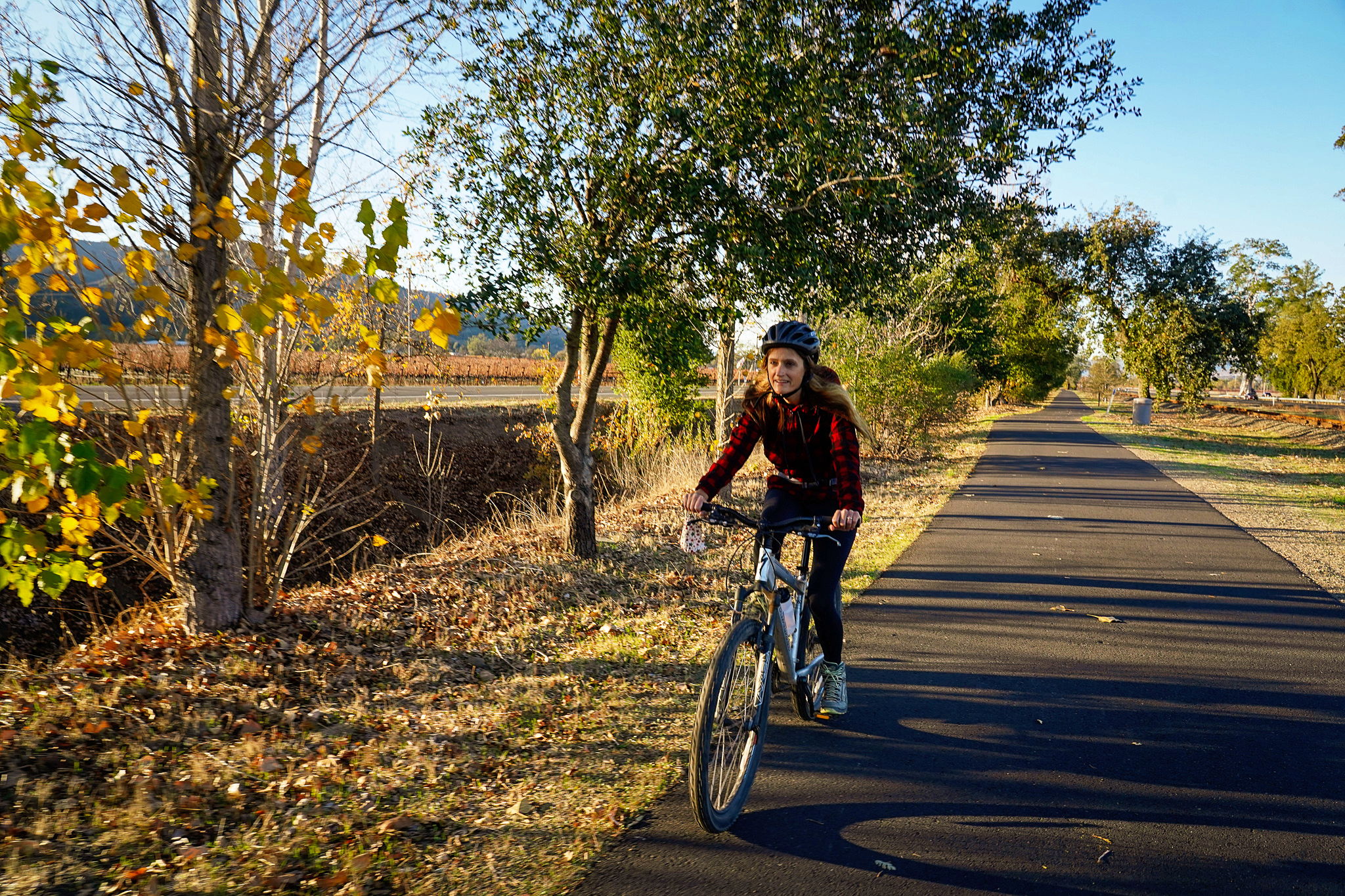 Woman riding a bike on the the Vine Trail in Napa Valley 