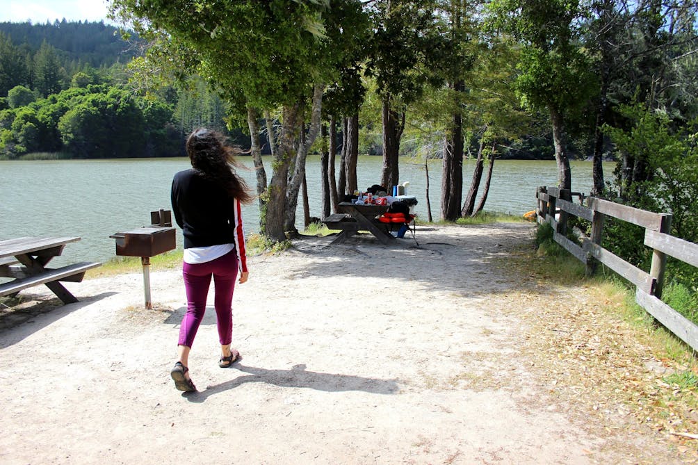 Person heading over to a picnic table on Clar Innis Island on Loch Lomond in the Santa Cruz Mountains