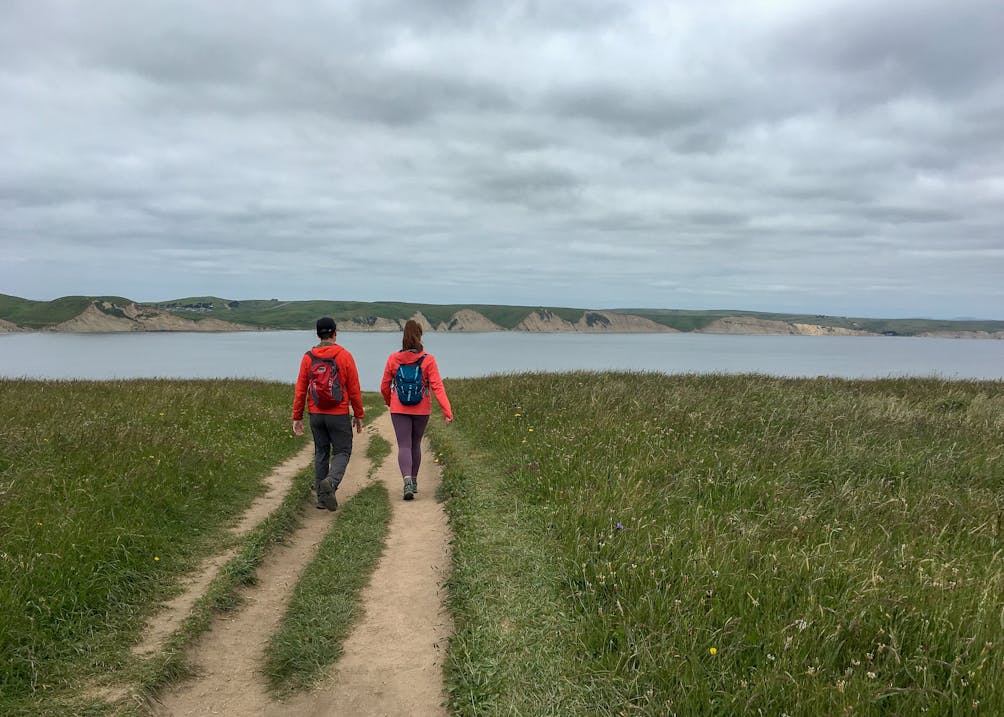 Two hikers on the trail at Chimney Rock in Point Reyes National Seashore