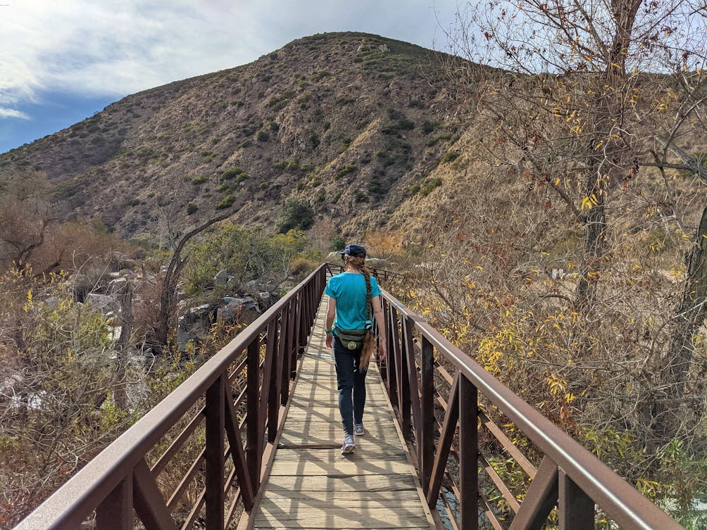 Woman walking over bridge at Mission Trails Regional Park in San Diego 