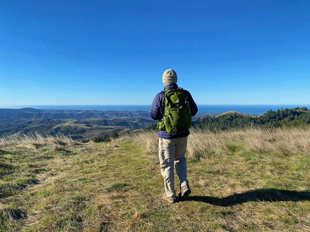 Man standing at viewpoint overlooking Santa Cruz Mountains at Upper La Honda Creek Preserve
