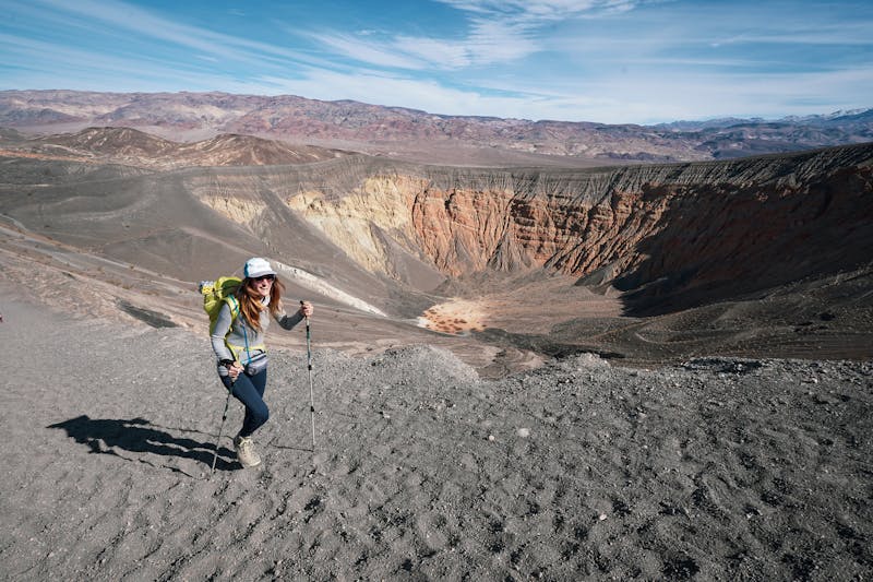 Woman hiking the trail around Ubehebe Crater in Death Valley National Park 