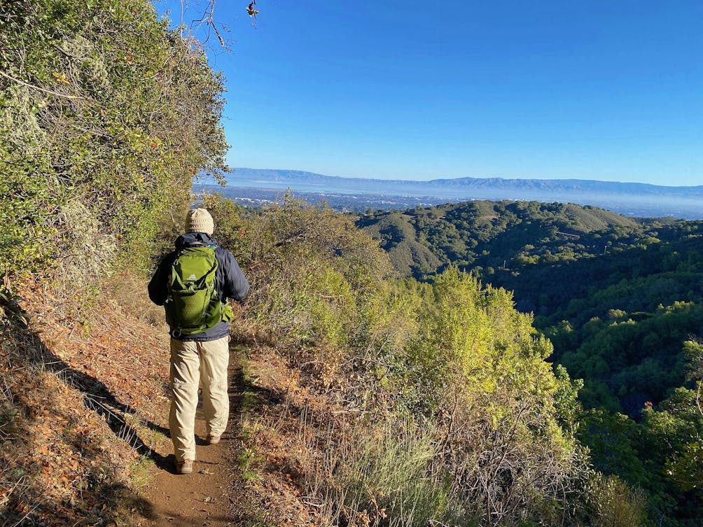 Man hiking a trail overlooking Palo Alto at Foothills Park 
