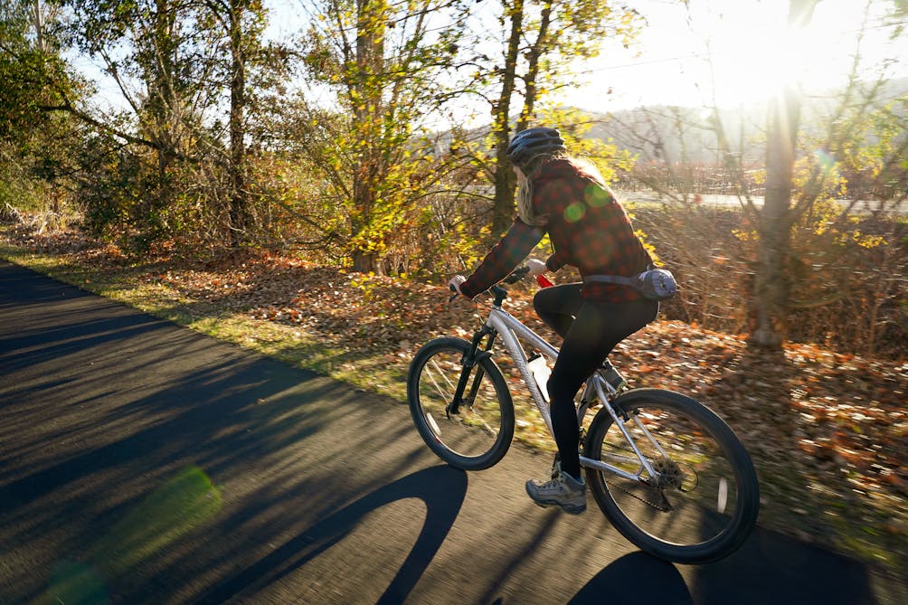 Woman biking on the Vine Trail in Napa Valley 
