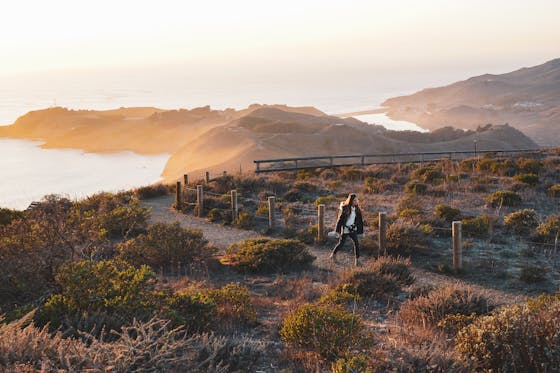 Woman hiking Hawk Hill in the Marin Headlands at Sunset