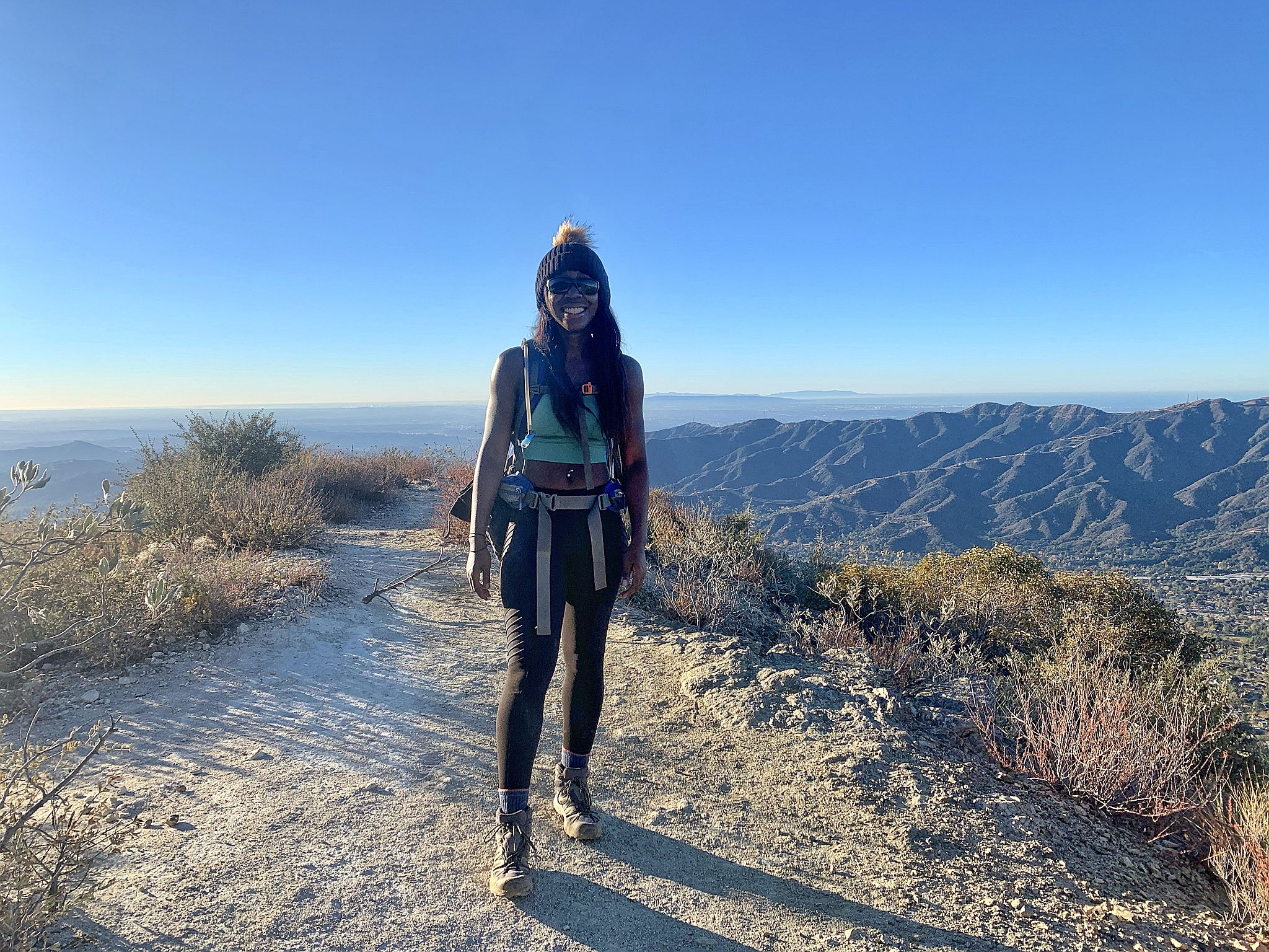 woman standing at the peak of Mount Lukens in Los Angeles