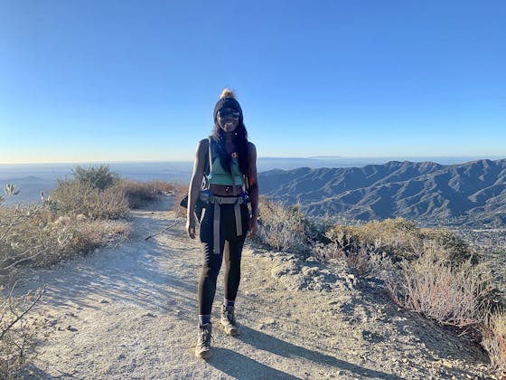 woman standing at the peak of Mount Lukens in Los Angeles