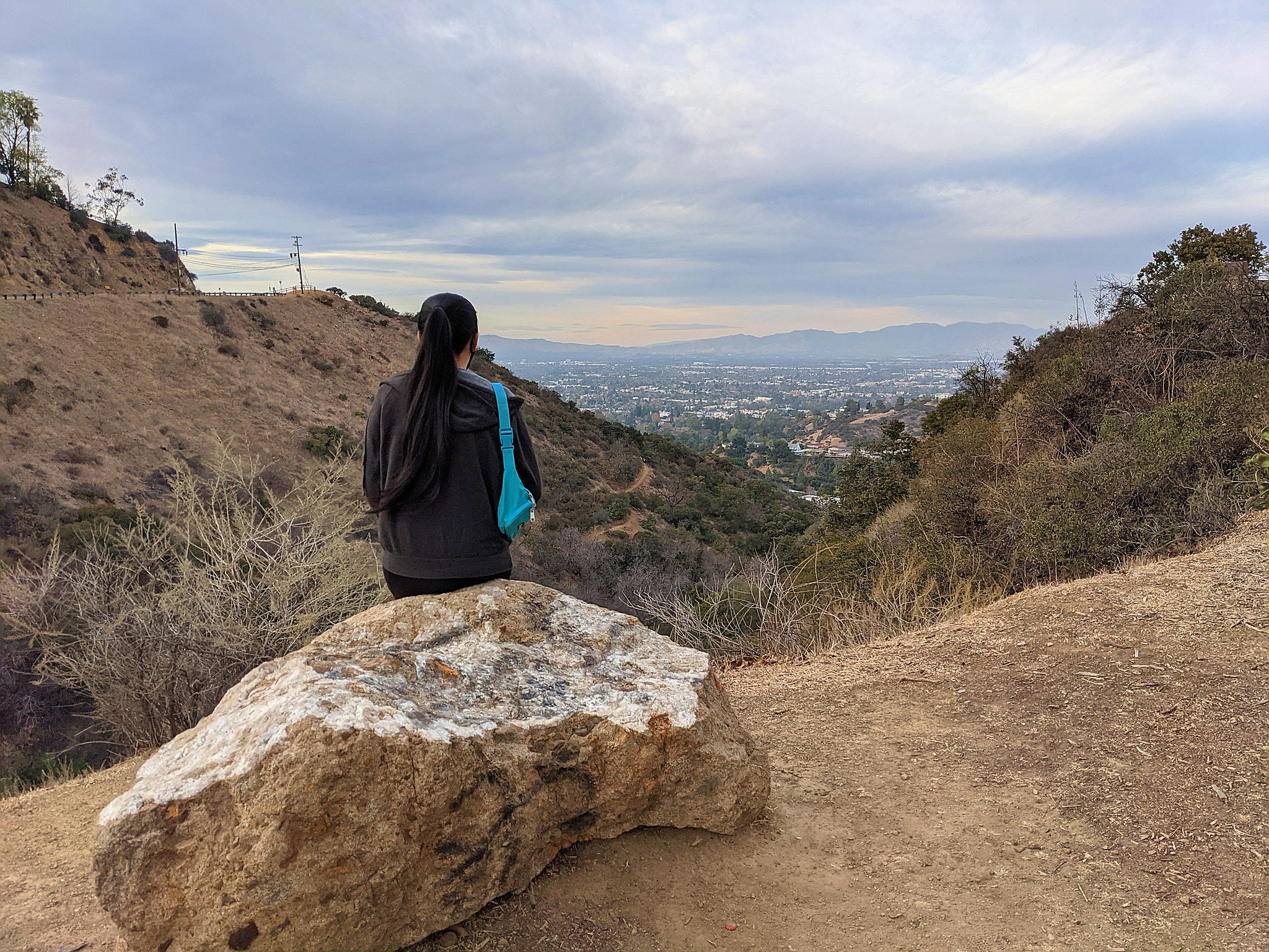 Woman at Nancy Hoover Pohl Overlook in Hollywood, taking in the views of San Fernando Valley