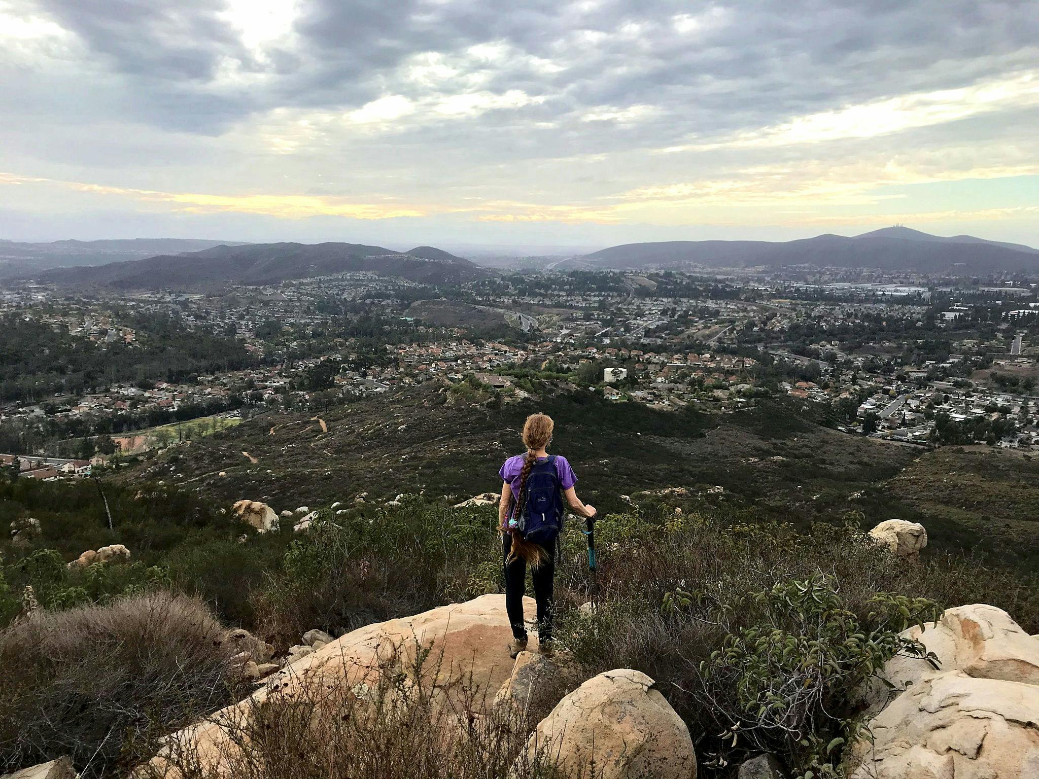 Woman standing at peak at Twin Peaks in San Diego 
