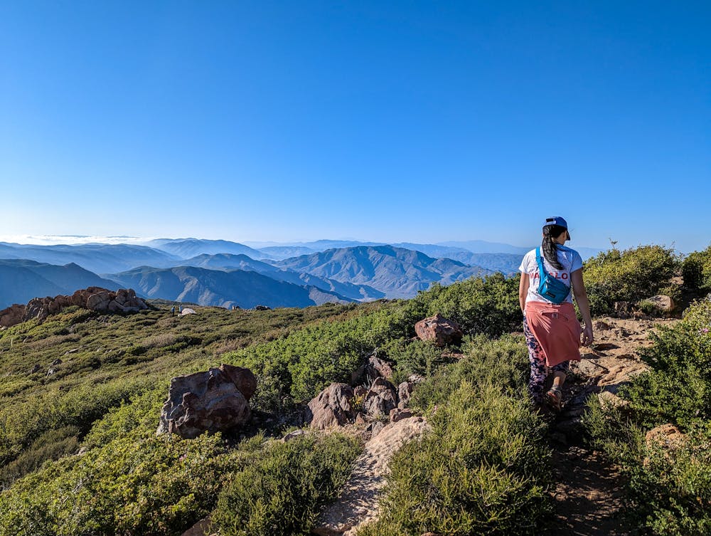 Woman standing at a high point on Garnet Peak in San Diego County 