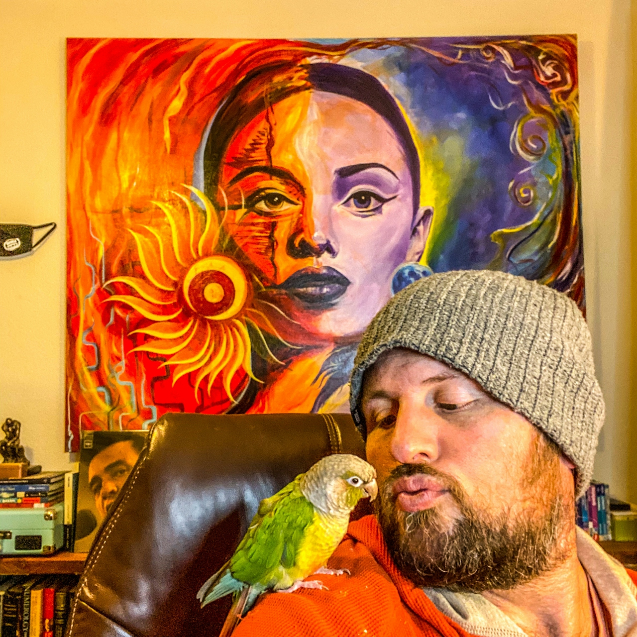 Jesse James Ziegler, Reno's Poet Laureate, and an orange and yellow pet parrot on his shoulder