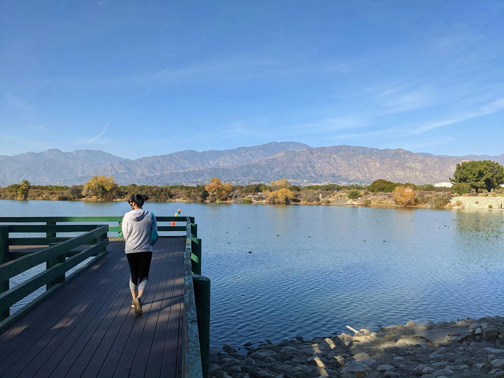 Woman on a boardwalk overlooking Santa Fe Dam in Los Angeles County 
