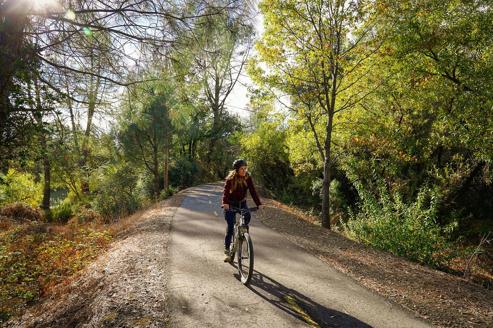 Woman biking on the El Dorado Trail in Placerville 
