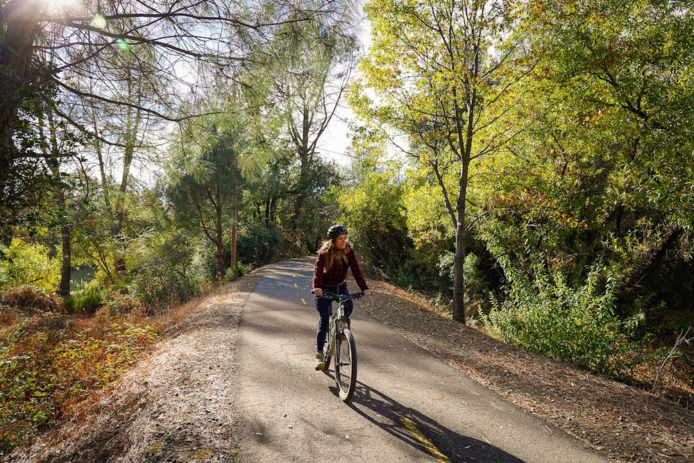Woman biking on the El Dorado Trail in Placerville 