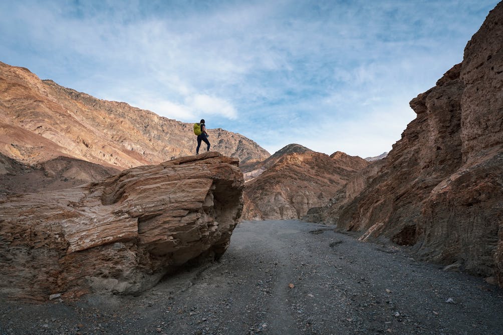Woman on a large boulder overlooking Mosaic Canyon in Death Valley National Park
