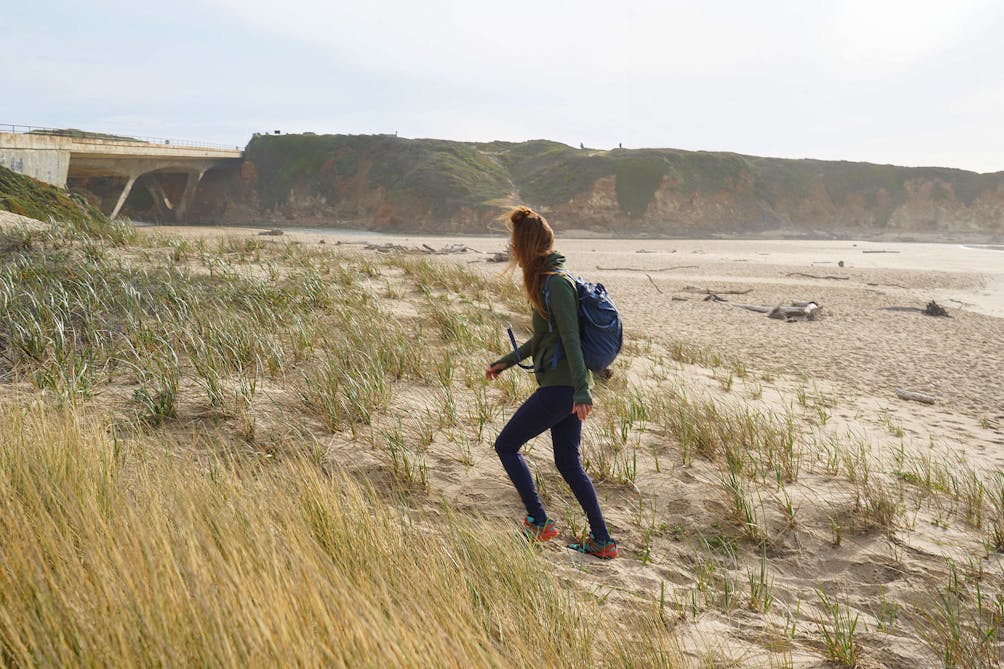 Woman walking on Pescadero State Beach 